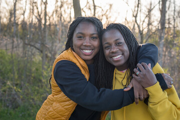 Smiling hugging sisters