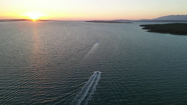 Active holiday in Croatia with beautiful sunset and powerboat cruise .
