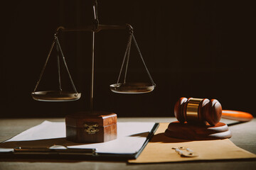 law legal technology concept. judge gavel on computer with scales of justice on desk of lawyer.