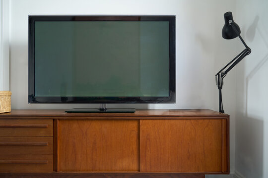 TV on mid century modern cabinet