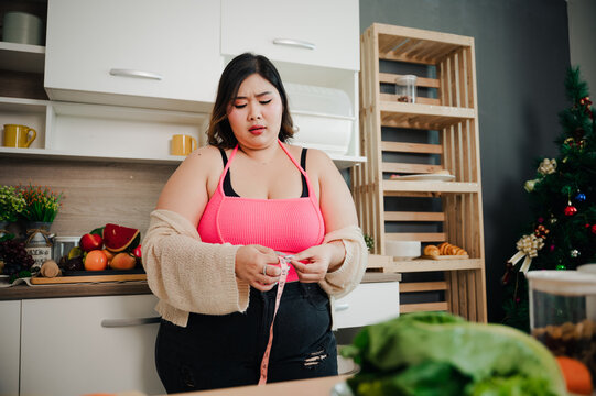 Plus size , fat woman, fat belly, chubby, depressed overweight at kitchen, Overweight woman measuring her fat belly.
