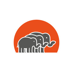 A herd of elephants against the background of the sun. Vector logo.
