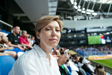 Portrait of woman spectator at sports stadium.