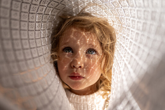 A toddler with shadow on her face