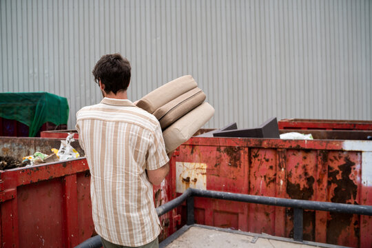 Man dumping furniture at recycling clean point