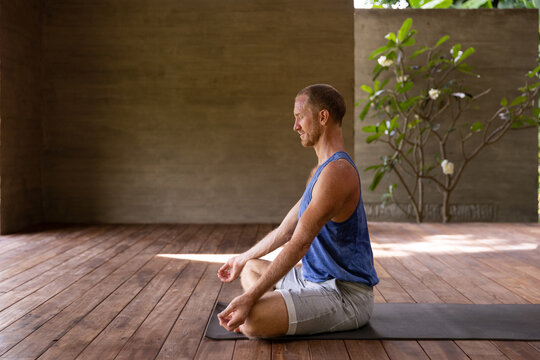 Adult man meditating in yoga studio