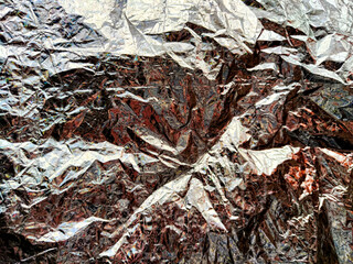 Beautiful abstract background and texture of crumpled aluminum foil in green color. Pattern, place...