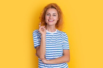 happy redhead woman portrait isolated on yellow background. portrait of young redhead woman