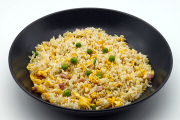 Cantonese Rice in a black dish isolated on white background.