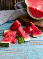 Watermelon slices in a glass on a wooden background. 
Slices of watermelon on a wooden board. 