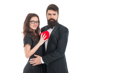 Feeling happiness. engagement. elegant couple formal event. love and romance. romantic date man and woman. happy valentines day. tuxedo man beard and girl in glasses. formal couple in love hold heart