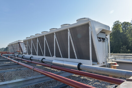 double stack dry cooler on a roof next to a forest with blue sky - hot or cool fluid and air exchange system