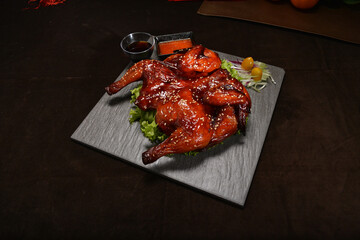 roasted bbq whole china honey chicken meat in crispy skin w sweet honey sauce and sesame on dark background asian Chinese halal food menu for banquet restaurant