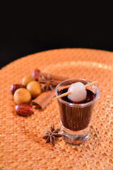 chilled cocktail mocktail short glass wine with mandarin orange fruit juice kombucha vodka alcohol cinnamon longan drink on gold plate dark background bar cuisine menu for hotel pub