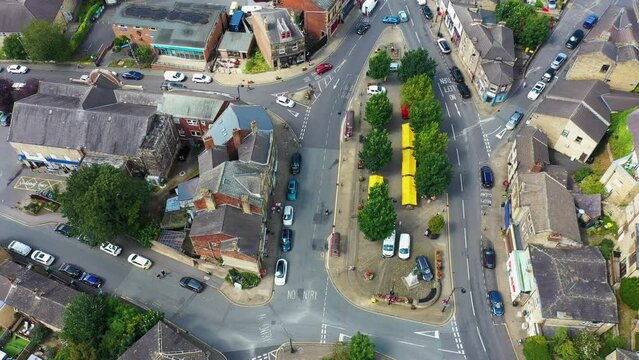 Aerial footage of the beautiful historical town of Batley in the Metropolitan Borough of Kirklees, West Yorkshire, England showing the historical town centre and market stalls in the summer