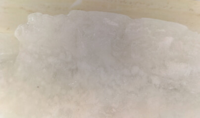 Closeup view of cold compartment with walls covered with ice in the refrigerator at home. High angle view of a pile of ice.
