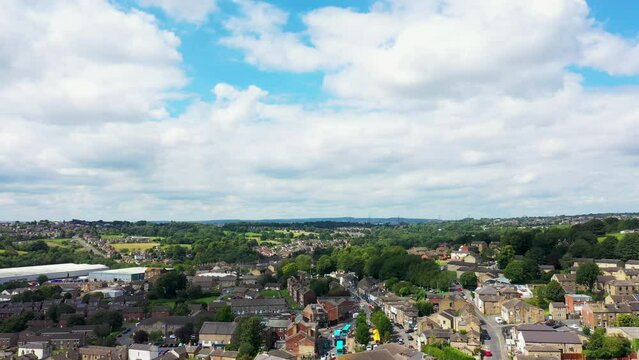 Aerial drone footage of the beautiful historical town of Batley in the Metropolitan Borough of Kirklees, West Yorkshire, England showing the historical town and clouds on a hot day in the summer time