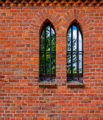 Fototapeta na wymiar General view and close-up architectural details of the Catholic Church of St. Holy Trinity in the town of Dwawrzuty in Masuria in Poland.