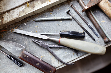 Repairing old damaged window or dismantling before installing new, closeup. Repairing a window frame, using instruments for renovation old windows
