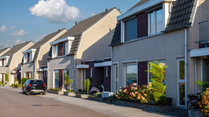 Dutch Suburban area with modern family houses, modern brick houses in a family friendly suburban neighborhood in the Netherlands. - obrazy, fototapety, plakaty