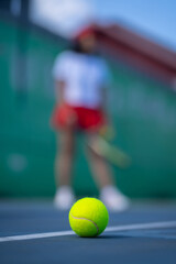 Closeup of a tennis ball lying on a tennis court