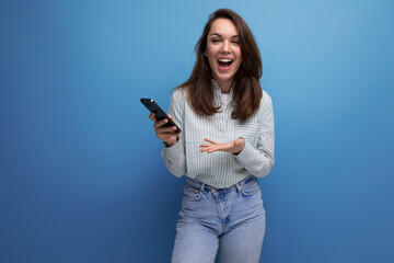 20s brunette lady with gorgeous hair makes a call on smartphone connection