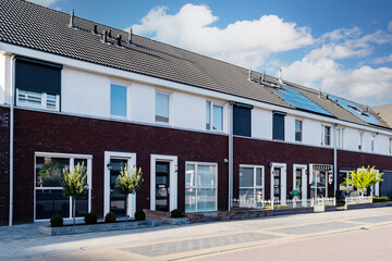 Dutch Suburban area with modern family houses, newly built modern family homes in the Netherlands, dutch family house in the Netherlands, Row of modern houses in contemporary neighborhood 