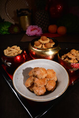 Chinese new year festival freshly baked assorted crispy cookies set with pineapple tart, almond, chocolate , coconut walnut, peanut and spicy shrimp floss roll in luxury asian red gold platter design
