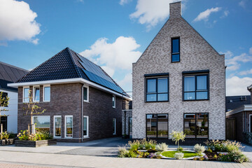 Dutch Suburban area with modern family houses, newly built modern family homes in the Netherlands, dutch family houses in the Netherlands, Modern Middle Class Real Estate on the Real Estate Market  - obrazy, fototapety, plakaty