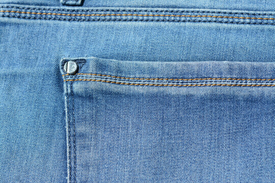 Pocket in blue jeans with rivets