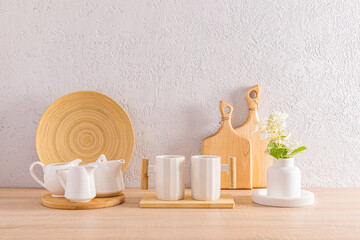 Stylish kitchen backdrop with white modern utensils and natural wooden cutting boards. Eco style. front view.