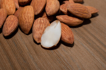 Almonds on brown wooden background