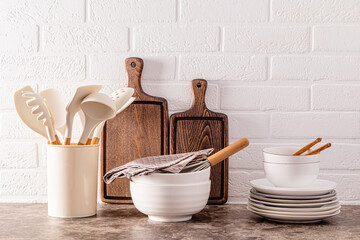 Fototapeta na wymiar Stylish modern kitchen background. Environmentally friendly items and utensils on a dark marble countertop in the interior of a cozy kitchen.