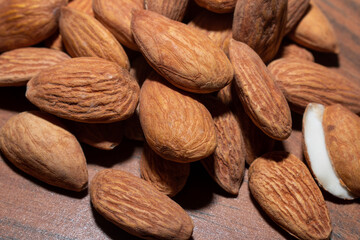 Almonds on brown wooden background