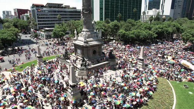 drone shot of people celebrating the pride parade in mexico city 2023 at the base of the independence monument