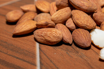 Almonds on brown wooden background