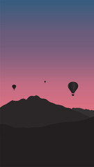 vector mountain and air balloons floating in the sunset sky