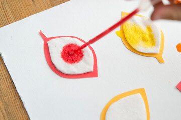 Autumn leaves. Child coloring tree leave shape cotton pads. Pipetting art. Montessori method employment for focus and concentration. Practical Life Skills, soothing activities.
