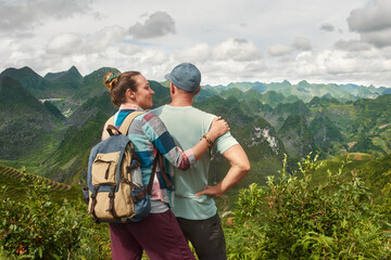 Family Couple traveling together on North Vietnam enjoying view of valley with mountains. Travel to Asia, happiness emotion, summer holiday concept. - 636206938