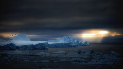 Antarctic landscape with icebergs in the ocean at sunset