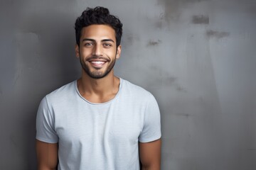 Handsome young man posing on grey background. Portrait of satisfied businessman against grey wall. Generative AI