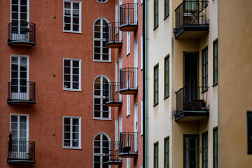 Fototapeta na wymiar Stockholm, Sweden A classic residential building courtyard with windows and balconies in orange and yellow.