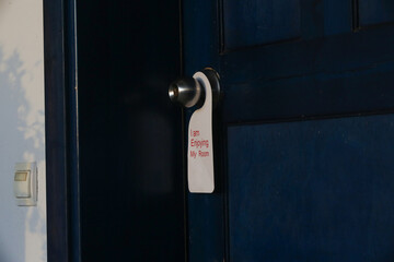 Hotel door privacy hanger. Enjoying my room tag hanging in the dor knob.	