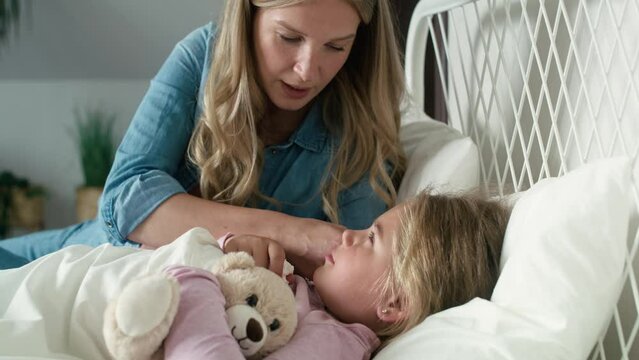 Mother taking care of her ill daughter at home. Shot with RED helium camera in 8K.