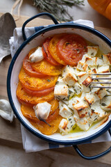 Low carb salad with oven baked feta cheese and tomatoes. Marinated with thyme and olive oil