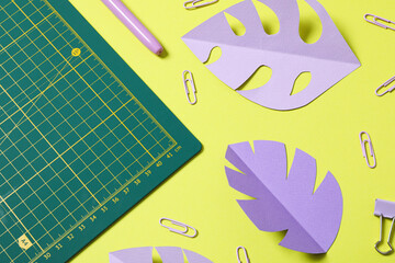 Patchwork accessories concept on yellow background, mat cutting