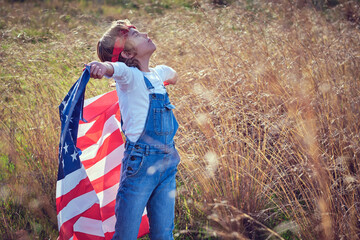 Boy with USA flag in nature