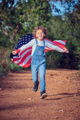 Active boy running with USA flag in rural area