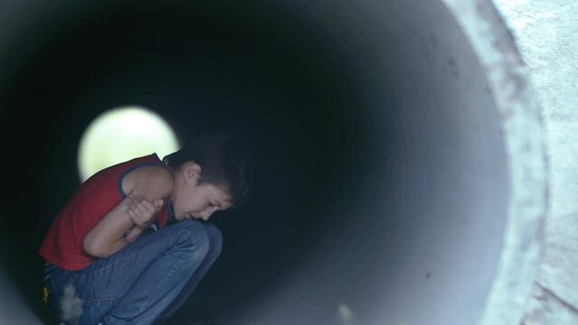 Warming Up: Boy Seeking Shelter from the Cold, Shivering and Trying to Warm Up