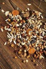 DRİED NUTS AND FRUİTS IN WOODEN BOWL ON BROWN FLOOR